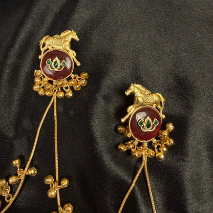 Traditional Gold Tone Horse Motif Earrings with Maroon Stone
