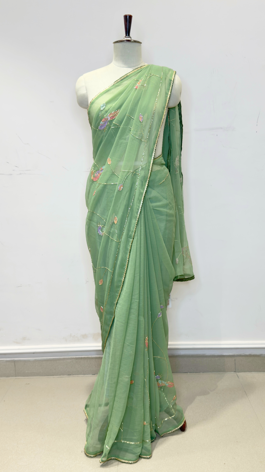 Banarashe Women’s Pastel Green Designer Saree with Multicolour Floral Embroidery & Golden Line Detailing