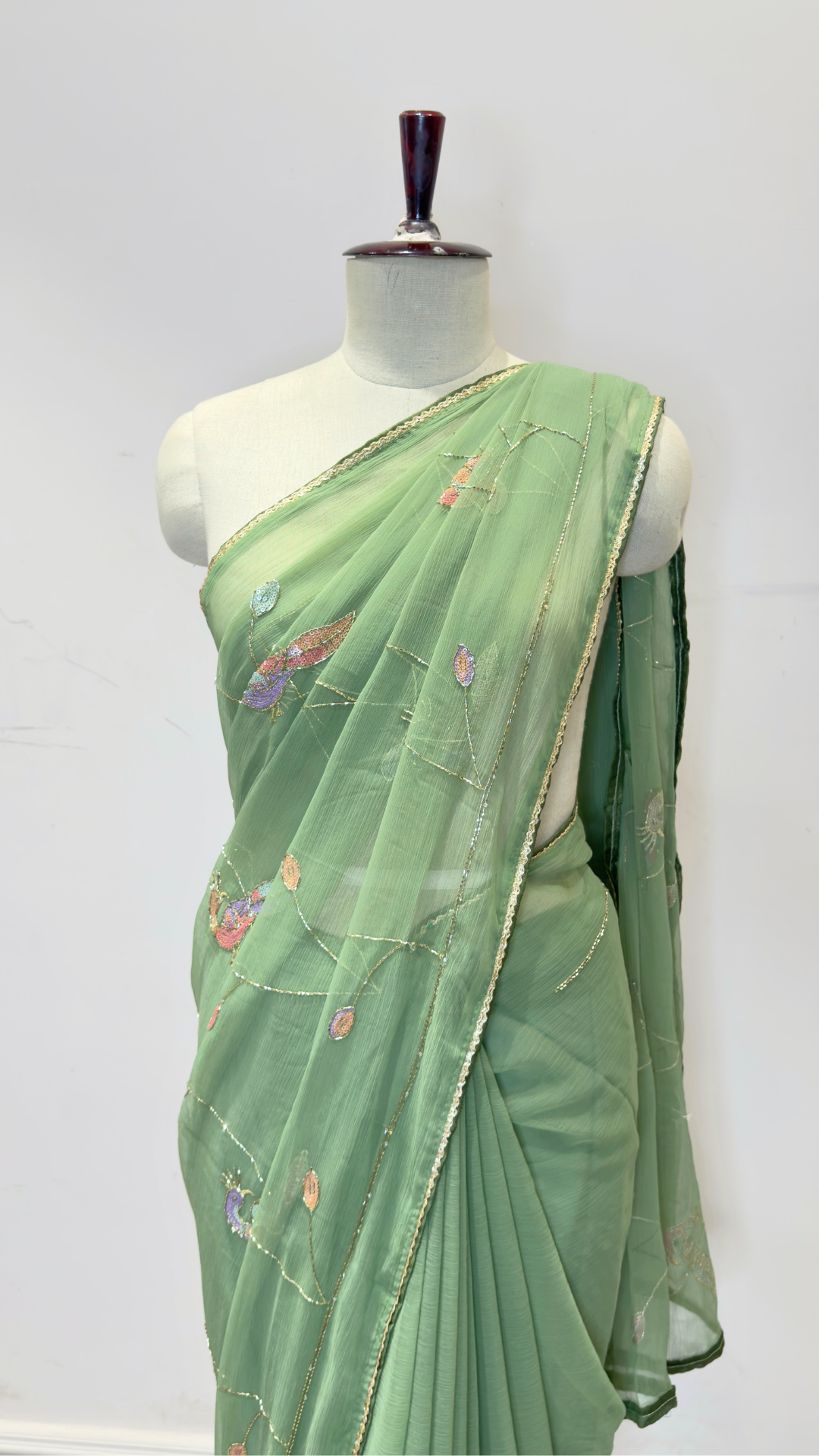 Banarashe Women’s Pastel Green Designer Saree with Multicolour Floral Embroidery & Golden Line Detailing