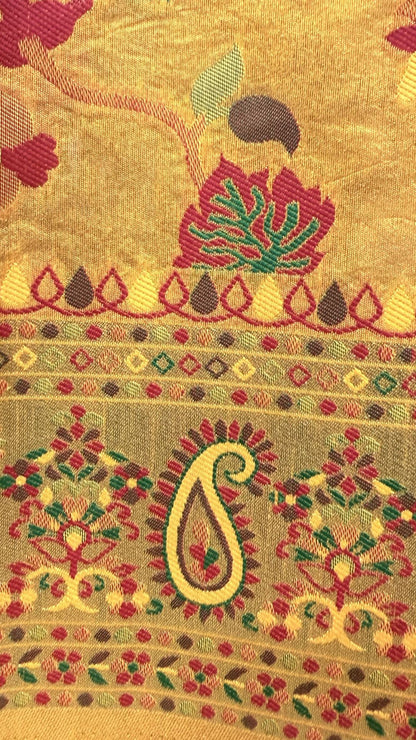 Decorative fabric with intricate patterns and colors on a gold background